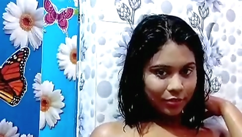 Beautiful brunette milf wearing a sexy outfit in shower