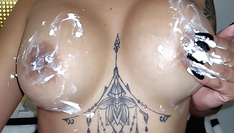 Tattooed girl shows her big tits in all the clothes