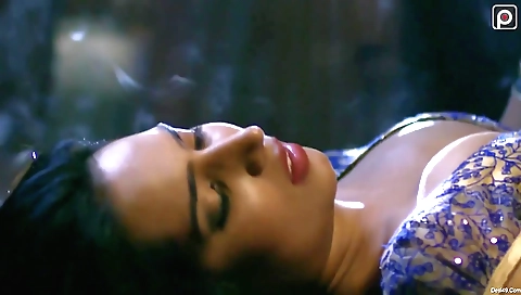 Busty brunette in a sexy outfit is playing with her clothes