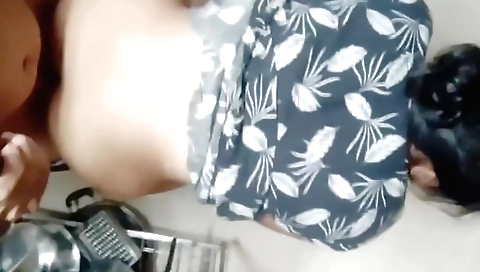 Brunette girl with big tits sucks a dildo in the kitchen