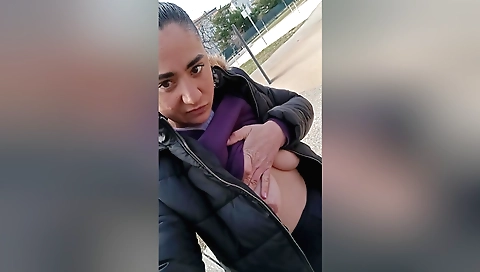 Amateur brunette shows her body in the public park