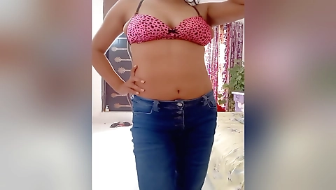 Indian beauty in a black dress and red hair in a solo video